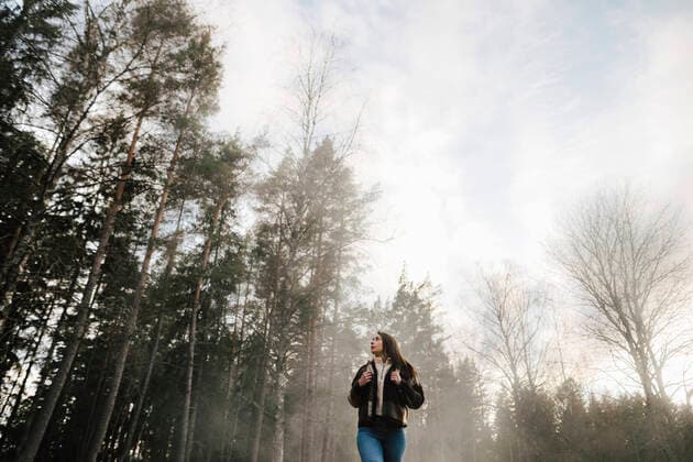 Low angle view of woman walking in forest during foggy weather Sweden, Stockholm Archipelago, model released Copyright: xMaskotx , MA87259