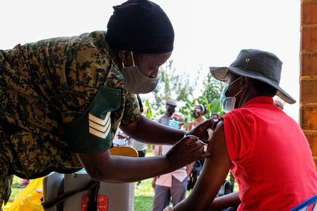 (210628) -- KAMPALA, June 28, 2021 -- A health worker administers a dose of the COVID-19 vaccine to a recipient in Kampala, Uganda, on June 28, 2021. Uganda on Monday resumed COVID-19 vaccination for health workers and those due to receive a second AstraZeneca jab after a three-week suspension. (Photo by Hajarah Nalwadda Xinhua) UGANDA-KAMPALA-COVID-19-VACCINATION ZhangxGaiping 