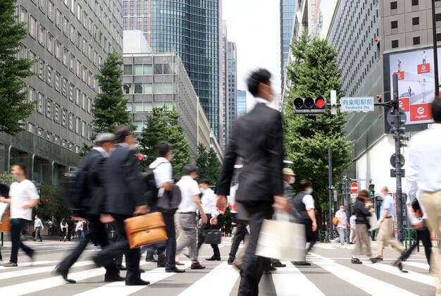 June 29, 2021, Tokyo, Japan - People cross a road in front of the Yurakucho station in Tokyo on Tuesday, June 29, 2021. Japan s jobless rate in May worsened to 3.0 percent, announced by Internal Affairs Ministry on June 29, the highest level in five months amid outbreak of the new coronavirus.  (163555449)