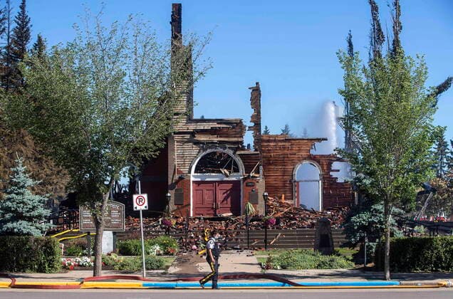 June 30, 2021, Morinville, ab, Canada: A police officer walks past St. John Baptiste Parish Catholic church in Morinville Alta, on Wednesday June 30, 2021. A Catholic Church in northern Alberta has been destroyed by what RCMP are calling a suspicious fire. RCMP say in a release that officers were called to the blaze at St. John Baptiste Parish in Morinville, about 40 kilometres north of Edmonton, just after 3 a.m. Morinville Canada  - ZUMAc35_ 20210630_zaf_c35_006 Copyright: xJasonxFransonx