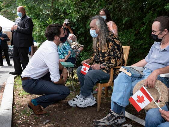 June 30, 2021, Ottawa, on, Canada: Prime Minister Justin Trudeau speaks with a man as he shakes hands outside the Shepherds of Good Hope residence following an announcement in Ottawa, Wednesday, June 30, 2021. Ottawa Canada  - ZUMAc35_ 20210630_zaf_c35_039 Copyright: xAdrianxWyldx