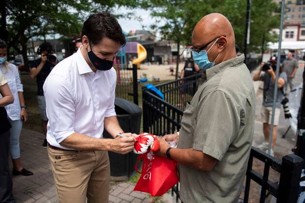 July 1, 2021, Ottawa, on, Canada: Prime Minister Justin Trudeau signs a pair of miniature boxing gloves for Amyn Keshavjee as he shops with his family at the Parkdale Public Market in Ottawa on Canada Day, Thursday, July 1, 2021. Ottawa Canada  - ZUMAc35_ 20210701_zaf_c35_021 Copyright: xJustinxTangx