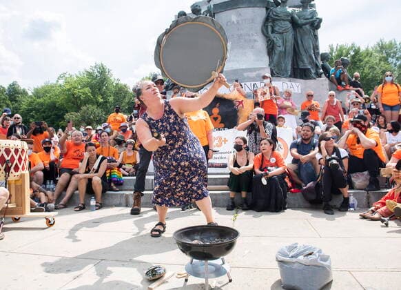 July 1, 2021, Montreal, PQ, Canada: A woman bangs on a drum during a gathering and march to honour Indigenous children, denounce genocide and demand justice for residential school victims in Montreal, Thursday, July 1, 2021. Montreal Canada  - ZUMAc35_ 20210701_zaf_c35_111 Copyright: xGrahamxHughesx