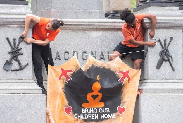 July 1, 2021, Montreal, PQ, Canada: People attach a banner to the plinth where the statue of John A MacDonald once stood during a gathering and march to honour Indigenous children, denounce genocide and demand justice for residential school victims in Montreal, Thursday, July 1, 2021. Montreal Canada  - ZUMAc35_ 20210701_zaf_c35_129 Copyright: xGrahamxHughesx
