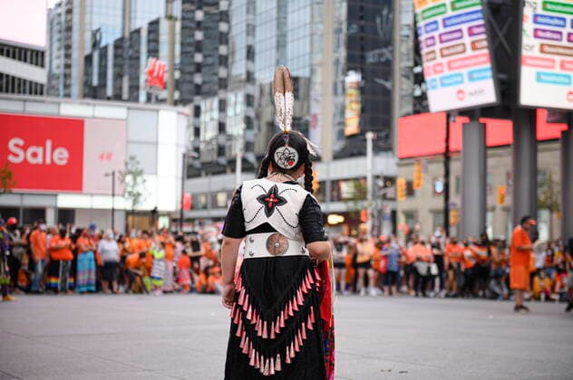 July 1, 2021, Toronto, on, Canada: A young Jingle Dancer looks on before performing for a crowd during a Cancel Canada Day rally in Toronto, on Thursday, July 1, 2021 to honour former residential school victims. Toronto Canada  - ZUMAc35_ 20210701_zaf_c35_252 Copyright: xChristopherxKatsarovx