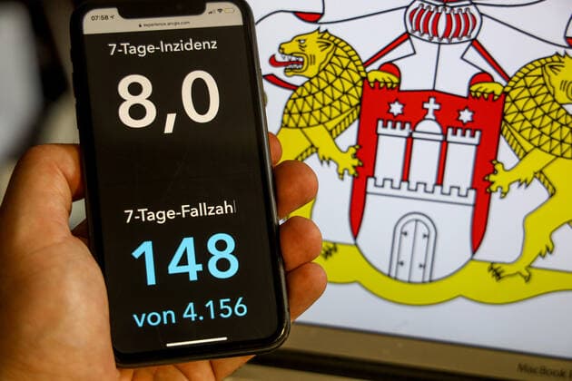 Coronavirus in Germany Covid 19 Dashboard of the Robert Koch Institute DEU, Germany, Hamburg, 02 07 2021 The 7 days incidence for the federal state cases last 7 days 100 000 EW is displayed on an iPhone, in the background the state coat of arms