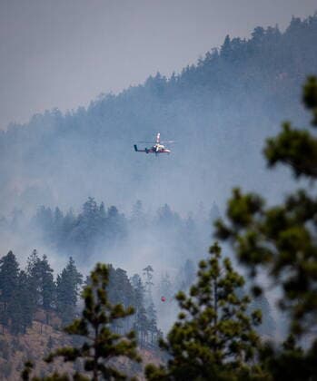 July 2, 2021, Lytton, BC, Canada: A helicopter pilot prepares to drop water on a wildfire burning in Lytton, B.C., on Friday, July 2, 2021. Lytton Canada  - ZUMAc35_ 20210702_zaf_c35_037 Copyright: xDarrylxDyckx