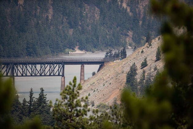 July 2, 2021, Lytton, BC, Canada: A rail bridge spans the Fraser River as a wildfire burns in Lytton, B.C., on Friday, July 2, 2021. Lytton Canada  - ZUMAc35_ 20210702_zaf_c35_048 Copyright: xDarrylxDyckx