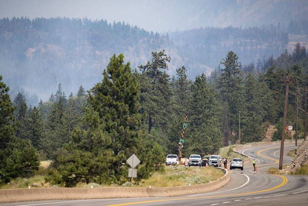 July 2, 2021, Lytton, BC, Canada: RCMP officers man a roadblock on the Trans-Canada Highway as wildfire burns in Lytton, B.C., on Friday, July 2, 2021. Lytton Canada  - ZUMAc35_ 20210702_zaf_c35_050 Copyright: xDarrylxDyckx