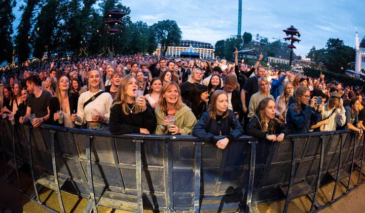 The audience for the Danish band Jung with Jonas Jung plays up to Havefest paa Plaenen in Tivoli on Friday 2 July 2021 with the audience divided into two sections Havefest replaces Fredagsrock, which has been canceled due to Covid 19 Corona crisis Photo Torben Christensen @ Copenhagen, Copenhagen  Copyright: TorbenxChristensen TorbenxChristensenx COP106 spdk20210703-010319-L