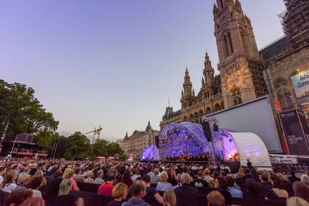 (210703) -- VIENNA, July 3, 2021 -- People watch the opening concert of the Cultural Summer Vienna and Rathausplatz Film Festival in Rathausplatz in Vienna, Austria, on July 3, 2021. Rathausplatz Film Festival held from July 3 to Sept. 4 opened here on Saturday. People can get access to the event free under the 3G rules, which are showing evidence of vaccination, a negative test or having recently recovered from the coronavirus. Meanwhile, a COVID-19 vaccination site has been set up here to provide walk-in COVID-19 vaccination for visitors during the film festival. ) AUSTRIA-VIENNA-RATHAUSPLATZ FILM FESTIVAL-COVID-19 VACCINATION GuoxChen 