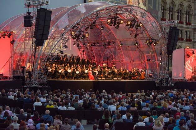 (210703) -- VIENNA, July 3, 2021 -- People watch the opening concert of the Cultural Summer Vienna and Rathausplatz Film Festival in Rathausplatz in Vienna, Austria, on July 3, 2021. Rathausplatz Film Festival held from July 3 to Sept. 4 opened here on Saturday. People can get access to the event free under the 3G rules, which are showing evidence of vaccination, a negative test or having recently recovered from the coronavirus. Meanwhile, a COVID-19 vaccination site has been set up here to provide walk-in COVID-19 vaccination for visitors during the film festival. ) AUSTRIA-VIENNA-RATHAUSPLATZ FILM FESTIVAL-COVID-19 VACCINATION GuoxChen 