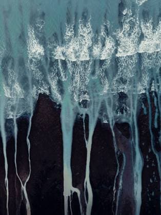 Creative Highlights World From above aerial textured landscape of rough uneven stony shore and foamy ocean waves with streams Copyright: xNicoxMortarinix Model Released