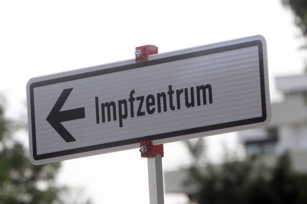 Signpost with directional arrow and inscription Impfzentrum is located in the city centre of Heidelberg, Baden Württemberg, Germany