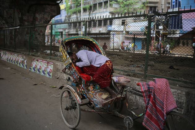 July 6, 2021, Dhaka, Bangladesh: A rickshaw puller fell asleep in his rickshaw as he was tired of not getting a passenger in the lockdown caused by the severe situation of lockdown in Dhaka, Bangladesh. Dhaka Bangladesh - ZUMAh355 20210706_zip_h355_011 Copyright: xMd.xRakibulxHasanx