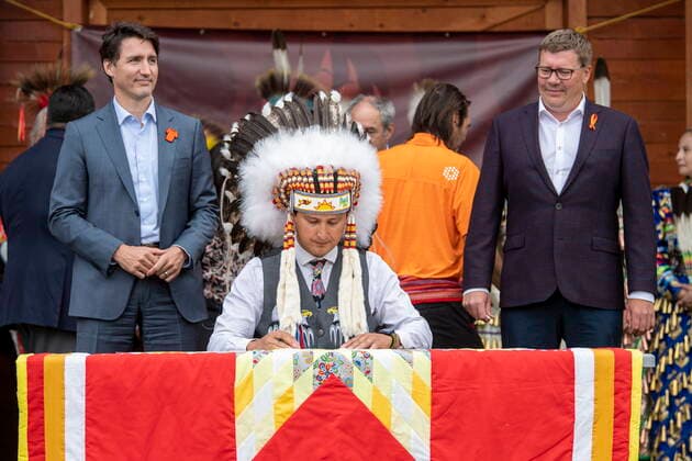 July 6, 2021, Cowessess First Nation, SK, Canada: Prime Minister Justin Trudeau, left to right, Chief Cadmus Delorme and Saskatchewan Premier Scott Moe sign a document of a transfer of control over children in care to the community during a ceremony, in Cowessess First Nation, Sask., Tuesday, July 6, 2021. Cowessess is also the site of a former residential school where, last month, ground-penetrating radar detected a potential 751 unmarked graves. Cowessess First Nation Canada - ZUMAc35_ 20210706_zaf_c35_071 Copyright: xLiamxRichardsx