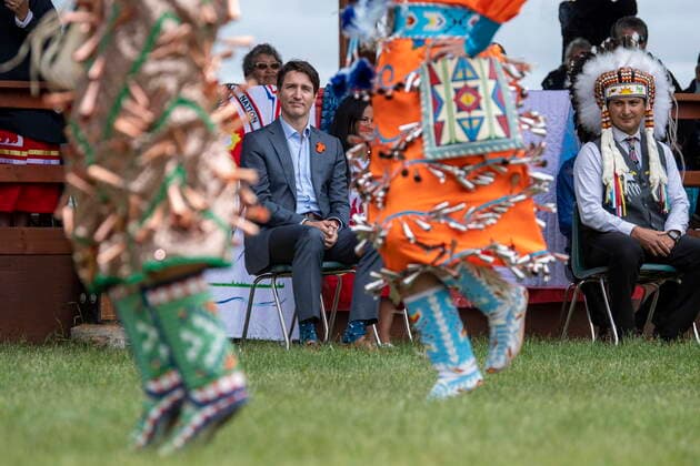 July 6, 2021, Cowessess First Nation, SK, Canada: Prime Minister Justin Trudeau, left, and Chief Cadmus Delorme watch dancers during a ceremony celebrating the signing of a transfer of control over children in care to the community, in Cowessess First Nation, Sask., Tuesday, July 6, 2021. Cowessess is also the site of a former residential school where, last month, ground-penetrating radar detected a potential 751 unmarked graves. Cowessess First Nation Canada - ZUMAc35_ 20210706_zaf_c35_076 Copyright: xLiamxRichardsx