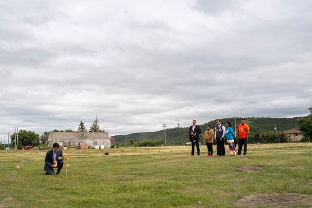 July 6, 2021, Cowessess First Nation, SK, Canada: Prime Minister Justin Trudeau, left, lays a teddy bear at a small flag in a field prior to a ceremony at the site of a former residential school where, last month, ground-penetrating radar detected a potential 751 unmarked graves, in Cowessess First Nation, Sask., Tuesday, July 6, 2021. Cowessess First Nation Canada - ZUMAc35_ 20210706_zaf_c35_090 Copyright: xLiamxRichardsx