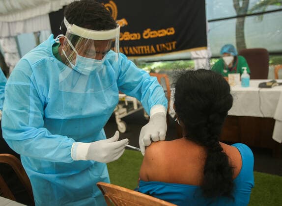 July 7, 2021, colombo, Sri Lanka: A Sri Lankan Army Medical officer administers a dose of Pfizer-BioNTech COVID-19 Vaccine to woman at Army Hospital vaccination site in Colombo, Sri Lanka, July 7, 2021. Sri Lankan health authorities on Wednesday began rolling out doses of the Pfizer vaccine for those who have received only the first dose of the AstraZeneca vaccine. colombo Sri Lanka. - ZUMAd152 20210707_znp_d152_001 Copyright: xPradeepxDambaragex