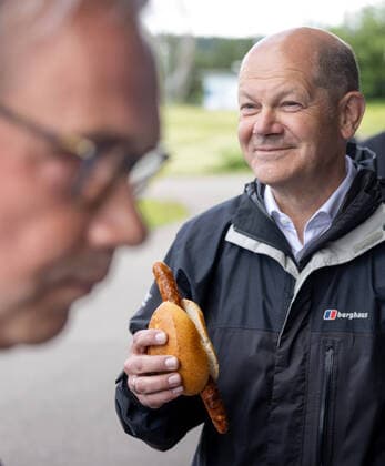 Chancellor candidate Olaf Scholz in Oberhof Olaf Scholz r , SPD candidate for chancellor, eats a bratwurst at the shooting sports center Scholz wants his visit to support Ullrichs candidacy in the contested constituency of southern Thuringia, where Maaßen is also running for the CDU Oberhof Thuringia GERMANY