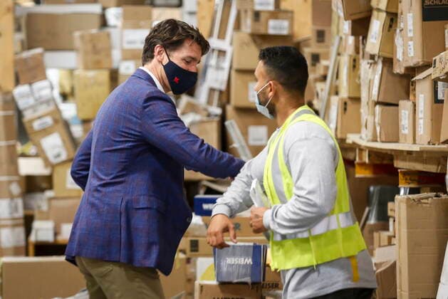 July 7, 2021, Calgary, ab, Canada: Prime Minister Justin Trudeau elbow bumps an employee as he tours the AAA Door company in Calgary, Alta., Wednesday, July 7, 2021. Calgary Canada  - ZUMAc35_ 20210707_zaf_c35_008 Copyright: xJeffxMcintoshx