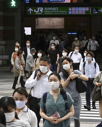 Scene from Tokyo amid coronavirus pandemic People wearing face masks walk in front of Tokyo Station in the Japanese capital on July 8, 2021, amid the coronavirus pandemic. 