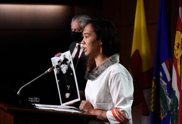 July 8, 2021, Ottawa, on, Canada: NDP MP Mumilaaq Qaqqaq speaks as NDP MP Charlie Angus holds a photo of Fr. Arthur Lavoie, who died in 1991 and was named in over 300 reports of physical and sexual abuse, as they arrive for a news conference calling on Minister of Justice David Lametti to investigate crimes against Indigenous people in Canada at residential schools, on Parliament Hill in Ottawa, on Thursday, July 8, 2021. Ottawa Canada - ZUMAc35_ 20210708_zaf_c35_002 Copyright: xJustinxTangx