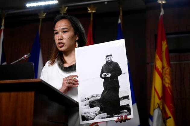 July 8, 2021, Ottawa, on, Canada: NDP MP Mumilaaq Qaqqaq holds a photo of Fr. Johannes Rivoire, who is wanted in Canada for abusing children in Nunavut but now resides in France, as she speaks at a news conference calling on Minister of Justice David Lametti to investigate crimes against Indigenous people in Canada at residential schools, on Parliament Hill in Ottawa, on Thursday, July 8, 2021. Ottawa Canada - ZUMAc35_ 20210708_zaf_c35_003 Copyright: xJustinxTangx