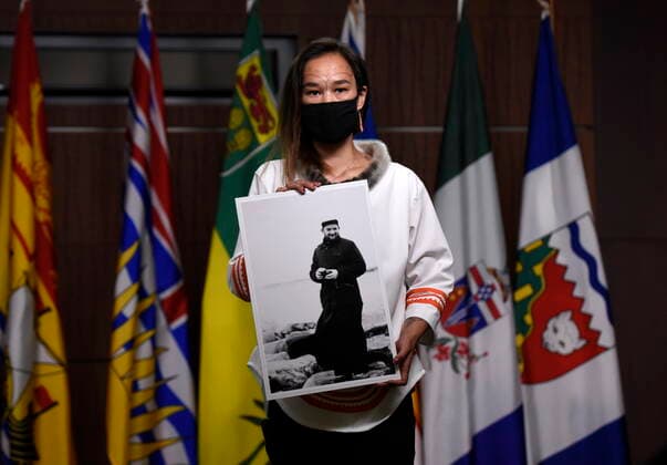 July 8, 2021, Ottawa, on, Canada: NDP MP Mumilaaq Qaqqaq holds a photo of Fr. Johannes Rivoire, who is wanted in Canada for abusing children in Nunavut but now resides in France, at a news conference calling on Minister of Justice David Lametti to investigate crimes against Indigenous people in Canada at residential schools, on Parliament Hill in Ottawa, on Thursday, July 8, 2021. Ottawa Canada - ZUMAc35_ 20210708_zaf_c35_004 Copyright: xJustinxTangx