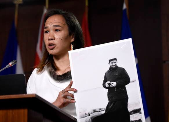 July 8, 2021, Ottawa, on, Canada: NDP MP Mumilaaq Qaqqaq holds a photo of Fr. Johannes Rivoire, who is wanted in Canada for abusing children in Nunavut but now resides in France, during a news conference calling on Minister of Justice David Lametti to investigate crimes against Indigenous people in Canada at residential schools, on Parliament Hill in Ottawa, on Thursday, July 8, 2021. Ottawa Canada - ZUMAc35_ 20210708_zaf_c35_005 Copyright: xJustinxTangx