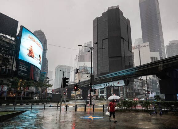 July 8, 2021, Kuala Lumpur, Malaysia: A pedestrian using an umbrella, walks along a deserted street during heavy downpour in downtown. Kuala Lumpur Malaysia - ZUMAs197 20210708_zaa_s197_063 Copyright: xWongxFokxLoyx