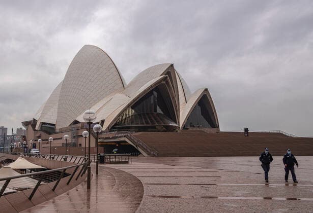 (210709) -- SYDNEY, July 9, 2021 -- Police officers patrol in front of Sydney Opera House in Sydney, Australia, on July 9, 2021. Australia s state of New South Wales Friday announced to further tighten restrictions on Greater Sydney and surrounding areas as the state continues to see a surge in daily increase of COVID-19 cases. ) AUSTRALIA-SYDNEY-COVID-19-RESTRICTIONS-TIGHTENING BaixXuefei 