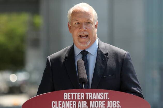 July 9, 2021, Surrey, BC, Canada: Premier John Horgan talks about the transit announcement at Surrey City Hall in Surrey, B.C., on Friday, July 9, 2021 as police and protesters gather below. Surrey Canada  - ZUMAc35_ 20210709_zaf_c35_052 Copyright: xChadxHipolitox
