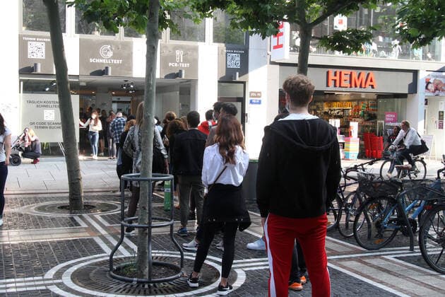 Large crowd of people wanting to take a free Corona quick test in front of a Corona testing center in the pedestrian zone and shopping street Zeil in downtown Frankfurt, Hesse, Germany