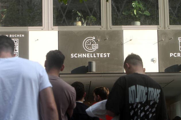 Large crowd of people wanting to take a free Corona quick test in front of a Corona testing center in the pedestrian zone and shopping street Zeil in downtown Frankfurt, Hesse, Germany