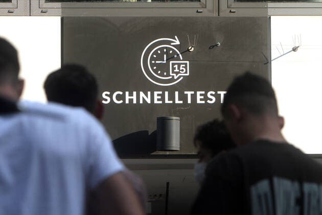 Large crowd of people wanting to take a free Corona quick test in front of a Corona testing center in the pedestrian zone and shopping street Zeil in downtown Frankfurt, Hesse, Germany