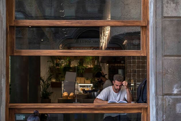 July 11, 2021, Barcelona, Spain: A man is seen inside a local restaurant reading a book..Barcelona suffers the effects of the fifth wave of the coronavirus with more than 8,000 new cases in the last 24 hours, predominantly of the delta variant. New restrictive measures will be taken in the next few hours. Barcelona Spain - ZUMAs197 20210711_zaa_s197_231 Copyright: xPacoxFreirex