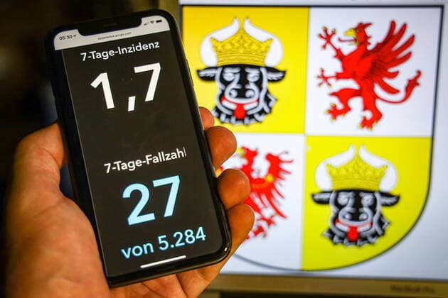 Coronavirus in Deutschland - Covid-19-Dashboard des Robert Koch-Institut DEU, Deutschland, Mecklenburg-Vorpommern, 12.07.2021: Die 7-Tage-Inzidenz für das Bundesland (Fälle letzte 7 Tage 100.000 EW) wird auf einem iPhone angezeigt, im Hintergrund das Landeswappen