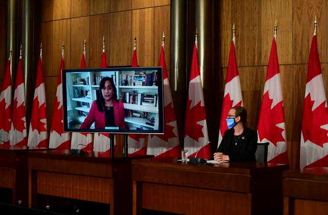 July 12, 2021, Ottawa, on, Canada: Anita Anand, Minister of Public Services and Procurement, speaks virtually as Karina Gould, Minister of International Development, looks on during a press conference in Ottawa on Monday, July 12, 2021, regarding Canadaâ€⠢s support for vaccination efforts in developing countries, humanitarian and conflict situations. Ottawa Canada - ZUMAc35_ 20210712_zaf_c35_007 Copyright: xSeanxKilpatrickx