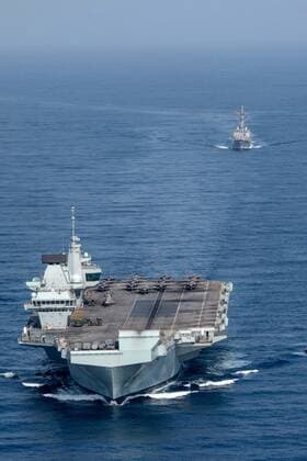 GULF OF ADEN (July 12, 2021) Royal Navy aircraft carrier HMS Queen Elizabeth (R 08), left, and guided-missile destroyer USS Halsey (DDG 97) operate in formation in the Gulf of Aden, July 12. UK, Dutch and U.S. naval forces conducted an integrated at-sea exercise designed to enhance maritime interoperability and demonstrate naval integration through a series of training scenarios. ( ) Where: Gulf of Aden When: 12 Jul 2021 Credit: US Navy Cover-Images.com **Editorial Use Only** Copyright: xx 41582255 EDITORIAL USE ONLY. NOT FOR USE BY NEWSPAPERS BASED IN THE UK.