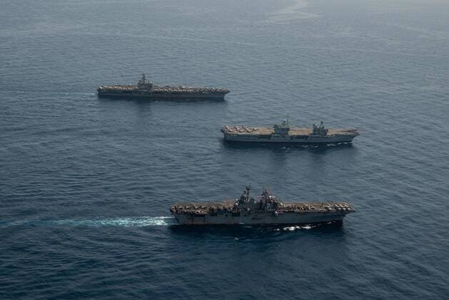 GULF OF ADEN (July 12, 2021) Amphibious assault ship USS Iwo Jima (LHD 7), front, Royal Navy aircraft carrier HMS Queen Elizabeth (R 08), and aircraft carrier USS Ronald Reagan (CVN 76) operate in formation in the Gulf of Aden, July 12. UK, Dutch and U.S. naval forces conducted an integrated at-sea exercise designed to enhance maritime interoperability and demonstrate naval integration through a series of training scenarios. ( ) Where: Gulf of Aden When: 12 Jul 2021 Credit: US Navy Cover-Images.com **Editorial Use Only** Copyright: xx 41582260 EDITORIAL USE ONLY. NOT FOR USE BY NEWSPAPERS BASED IN THE UK.
