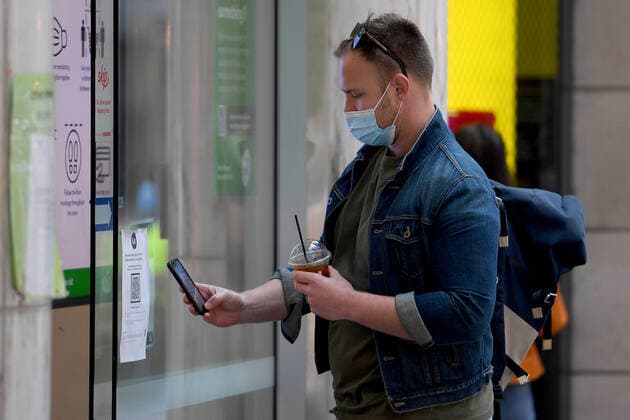 NSW CORONAVIRUS COVID19, A person uses a smart phone to check-in with a QR code at a supermarket in Pitt Street mall, in Sydney, Saturday, July 17, 2021. The stay-at-home orders for coronavirus-hit Greater Sydney and surrounds have been tightened with the lockdown extended for a further 2 weeks. ( NO ARCHIVING, EDITORIAL USE ONLY, NO USE IN BOOKS WITHOUT CONSENT SYDNEY NSW AUSTRALIA  Copyright: xDANxHIMBRECHTSx 20210717001557881075