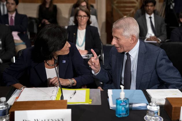 Dr. Anthony Fauci, director of the National Institute of Allergy and Infectious Diseases, right, speaks to Rochelle Walensky, Director of the Centers for Disease Control and Prevention, prior to testifying before the Senate Health, Education, Labor, and Pensions Committee at the Dirksen Senate Office Building in Washington on Tuesday, July 20, 2021. Health experts are to testify about the latest in the fight against the coronavirus. Pool WAXP20210720107 StefanixReynolds