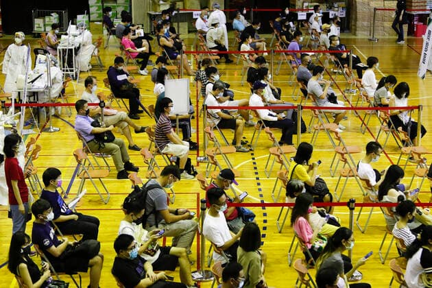 July 21, 2021, Taipei, Taipei, Taiwan: People wait to get inoculated with the vaccine against the coronavirus, at a vaccination site inside National Taiwan University Hospital, as the island is discussing the possibility of lowering the Covid-19 alert to a level 2. The island has been offering AstraZeneca, Moderna and Medigrn vaccines to boost its immunity rate. Taipei Taiwan - ZUMAs313 20210721_zip_s313_010 Copyright: xDanielxCengxShou-Yix