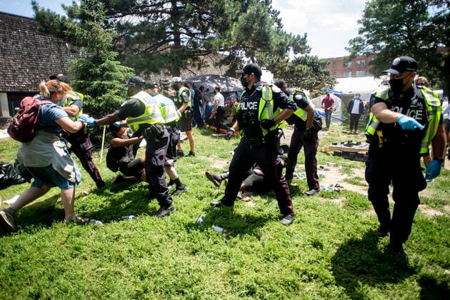 July 21, 2021, Toronto, on, Canada: Toronto police remove encampment supporters as they clear the Lamport Stadium Park encampment in Toronto on Wednesday July 21, 2021. The operation came a day after a different encampment was cleared at a downtown park. The city has cited the risk of fires and the need to make parks accessible to everyone as factors behind the clearings. Toronto Canada  - ZUMAc35_ 20210721_zaf_c35_012 Copyright: xChrisxYoungx