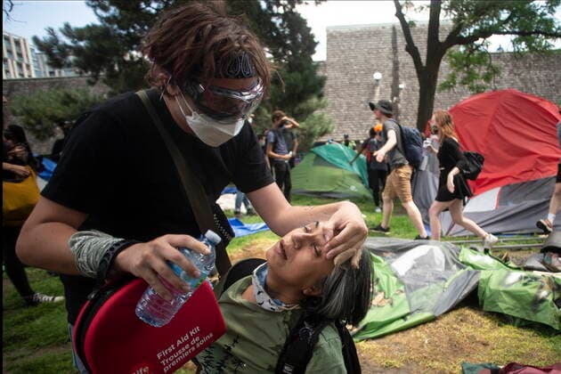 July 21, 2021, Toronto, on, Canada: An encampment supporter is treated for pepper spray as Police clear the Lamport Stadium Park encampment in Toronto on Wednesday July 21, 2021. The operation came a day after a different encampment was cleared at a downtown park. The city has cited the risk of fires and the need to make parks accessible to everyone as factors behind the clearings. Toronto Canada  - ZUMAc35_ 20210721_zaf_c35_015 Copyright: xChrisxYoungx