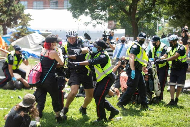 July 21, 2021, Toronto, on, Canada: Police remove encampment supporters as they clear Lamport Stadium Park encampment in Toronto on Wednesday July 21, 2021. The operation came a day after a different encampment was cleared at a downtown park. The city has cited the risk of fires and the need to make parks accessible to everyone as factors behind the clearings. Toronto Canada  - ZUMAc35_ 20210721_zaf_c35_018 Copyright: xChrisxYoungx