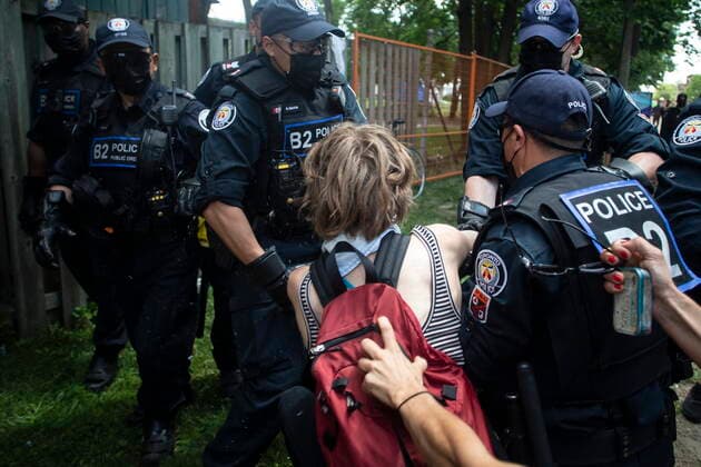 July 21, 2021, Toronto, on, Canada: Toronto police detain an encampment supporter as they clear the Lamport Stadium Park homeless encampment in Toronto on Wednesday, July 21, 2021. Toronto Canada  - ZUMAc35_ 20210721_zaf_c35_050 Copyright: xChrisxYoungx