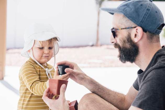 Bearded man playing with son in patio during vacation on sunny day model released Symbolfoto property released ACTF00135