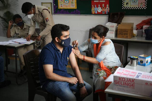NEW DELHI, INDIA - JULY 23: A health worker administers a Covid-19 vaccine to a person at a vaccination centre on Mandir Marg, on July 23, 2021 in New Delhi, India. (Photo by Sanchit Khanna Hindustan Times) COVID-19 Vaccination Drive
